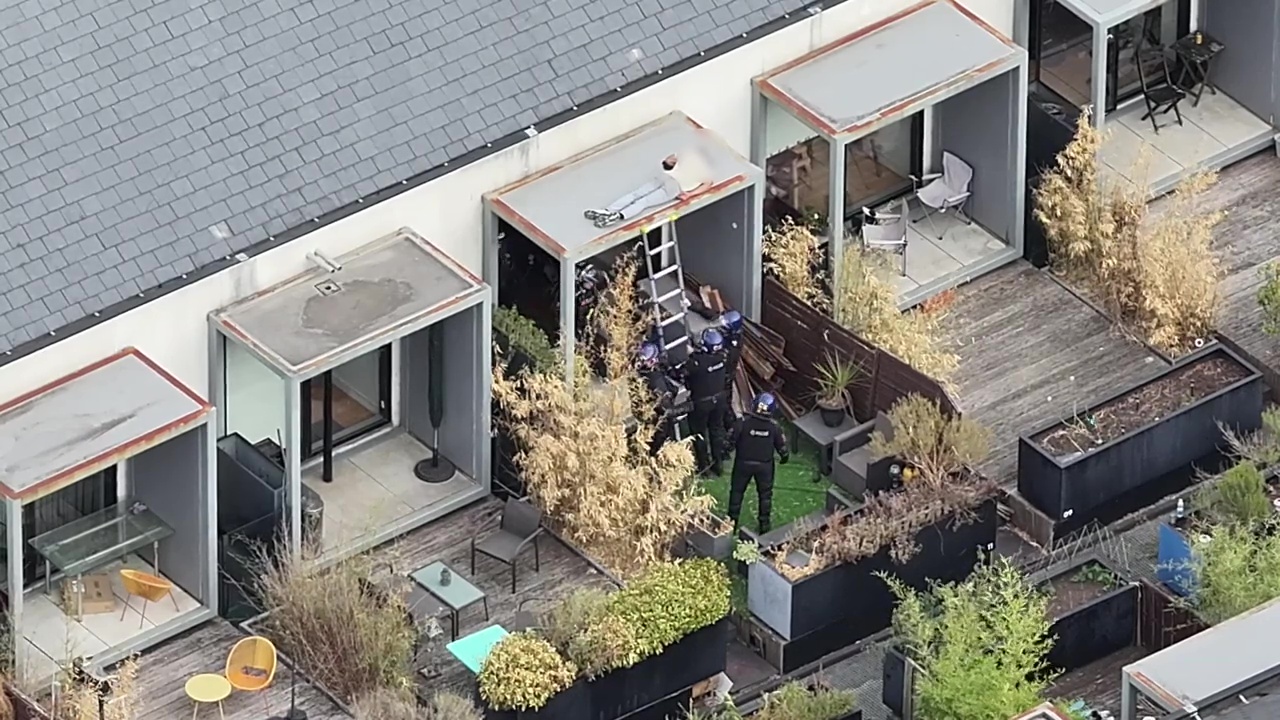 Moment riot cops drag snoozing suspect from rooftop after he ‘hurled tiles’ at officers during 48-hour stand-off