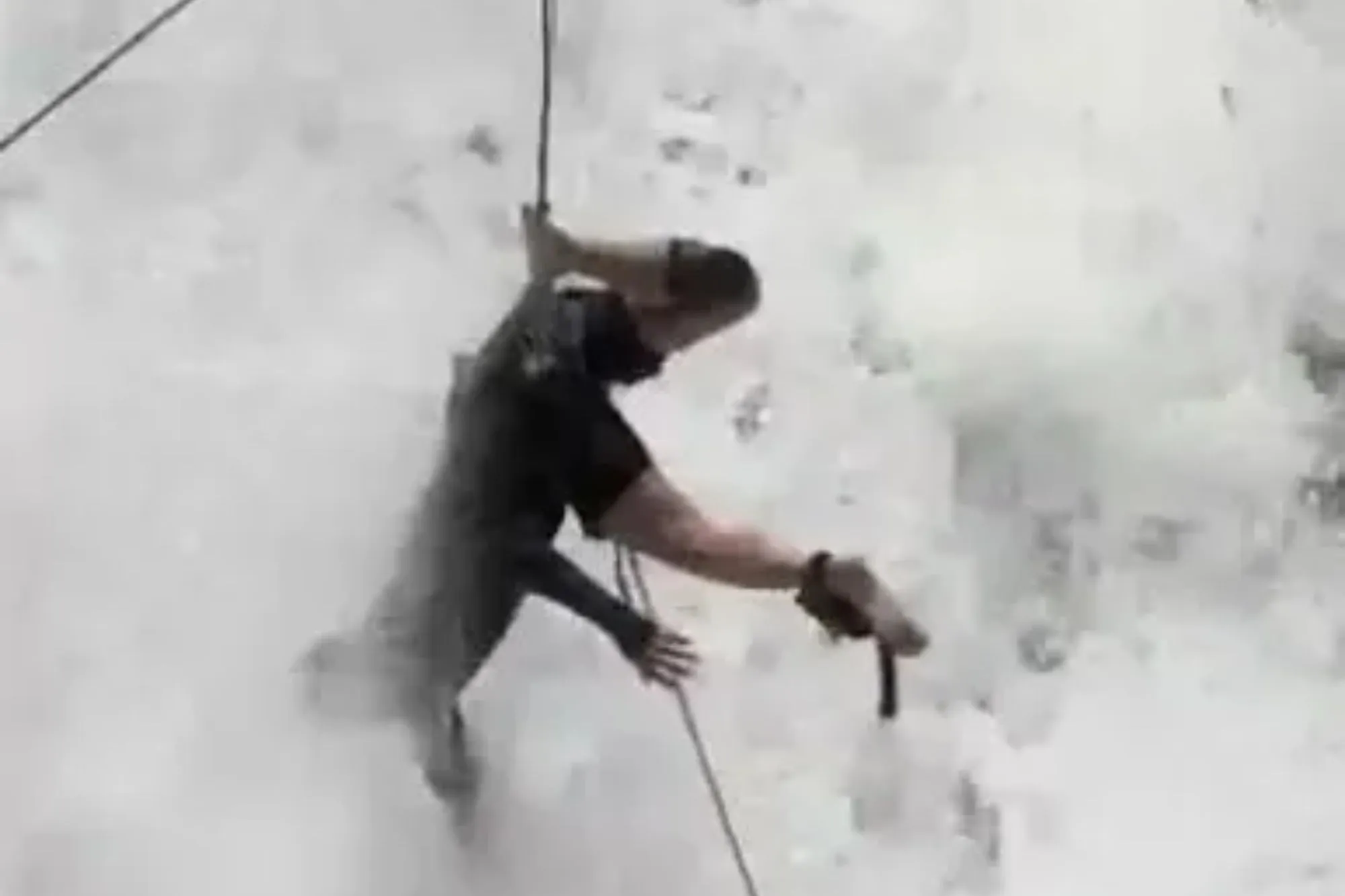 Moment tourist hangs by rope trapped mid-way down waterfall as he desperately flails to avoid drawing in strong current
