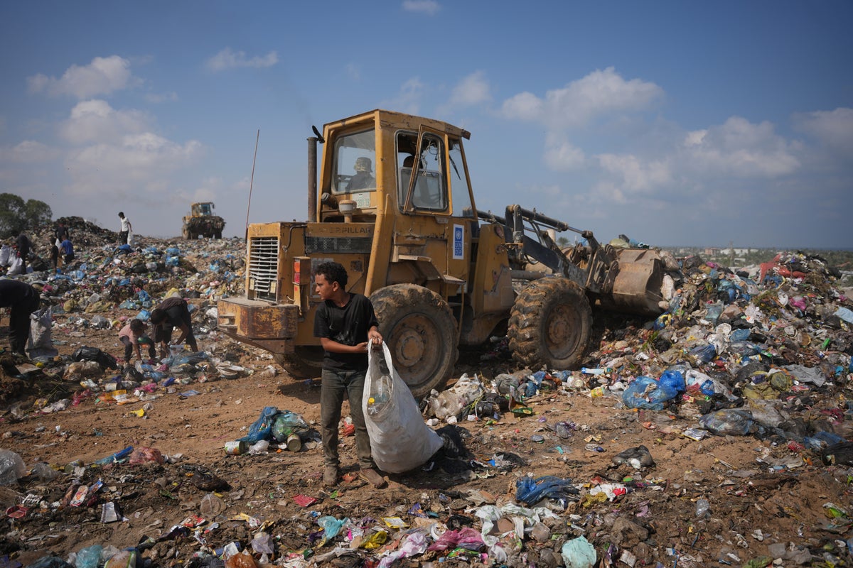 Palestinians in Gaza scavenge trash for things to burn to cook meals, in photos