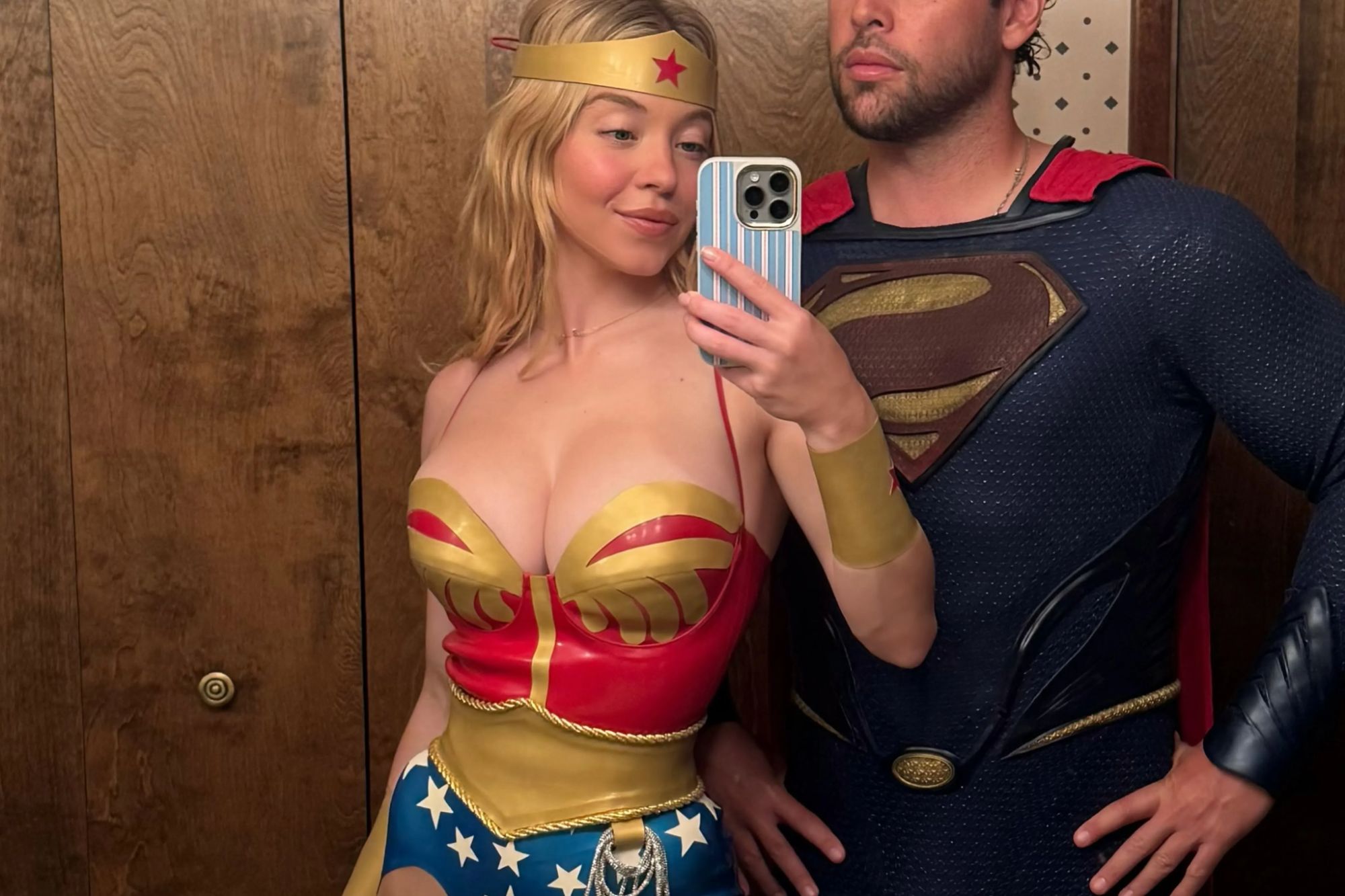 Sydney Sweeney’s skimpy Wonder Woman outfit clings on to her figure for dear life as she dresses as sexy superhero