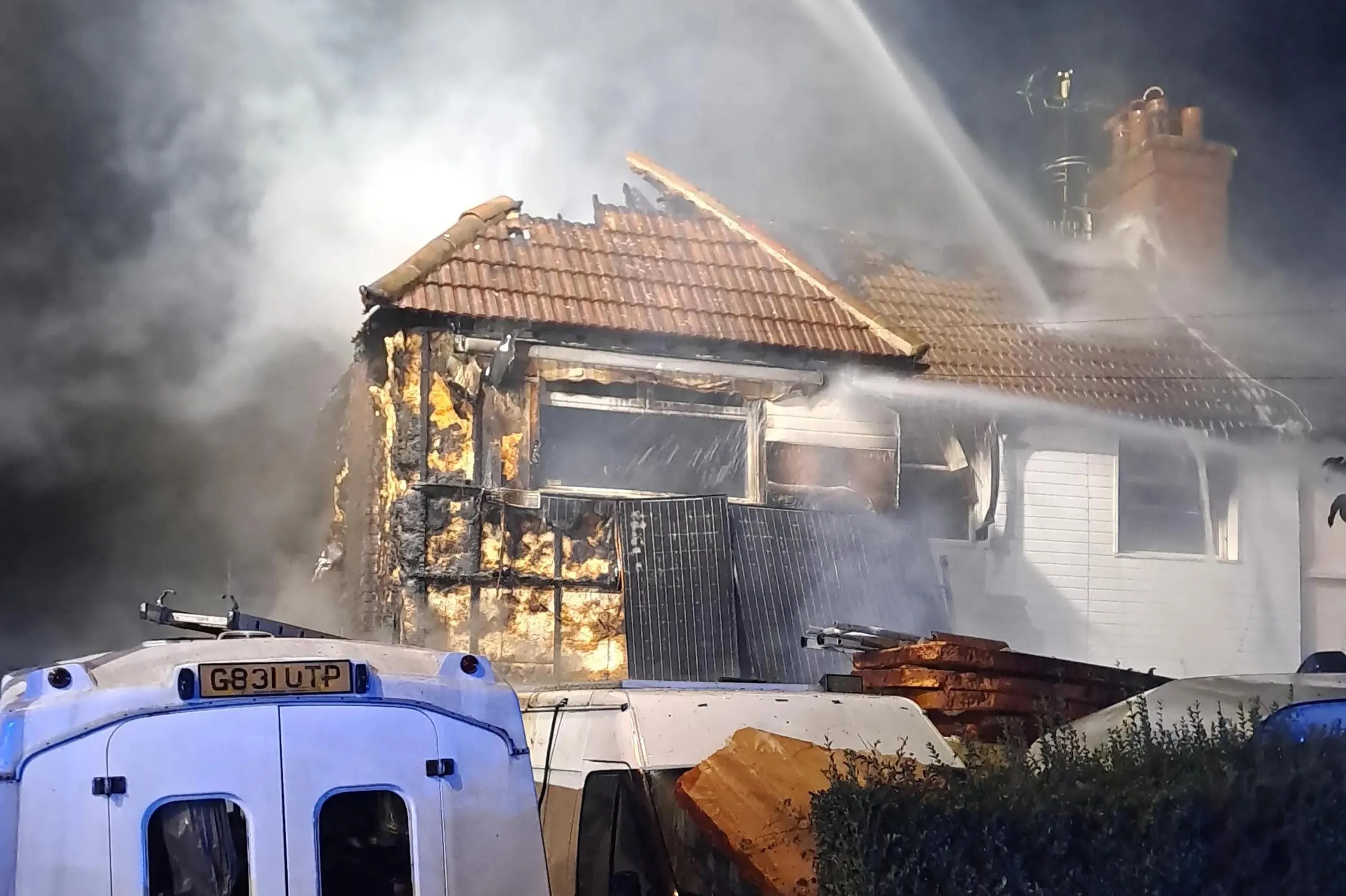 Massive blaze engulfs house and car in London as 70 firefighters scrambled – and locals urged to keep windows shut